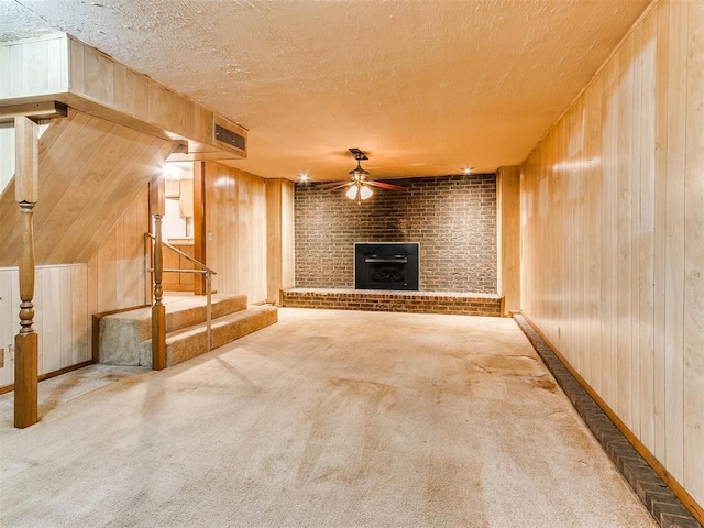 unfurnished living room featuring wood walls and carpet floors