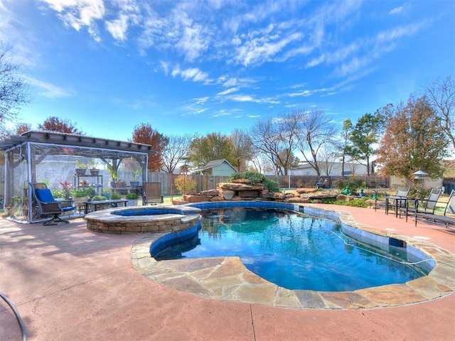 view of swimming pool with an in ground hot tub and a patio