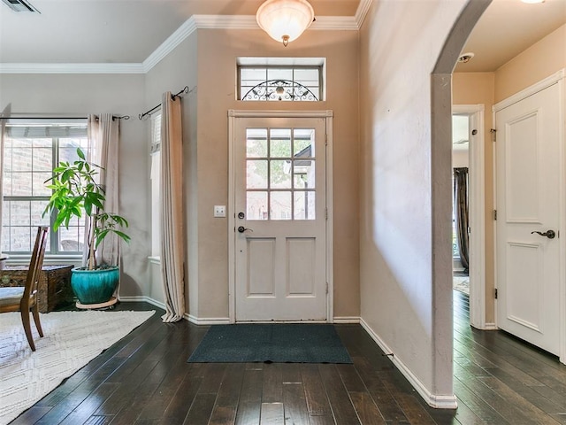 doorway with ornamental molding and dark wood-type flooring