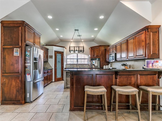 kitchen featuring stainless steel appliances, a kitchen breakfast bar, lofted ceiling, decorative backsplash, and light tile patterned floors