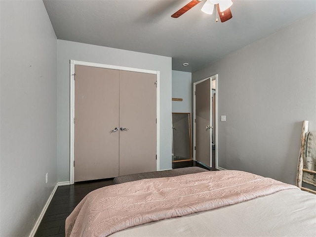 bedroom featuring ceiling fan, a closet, and dark hardwood / wood-style floors