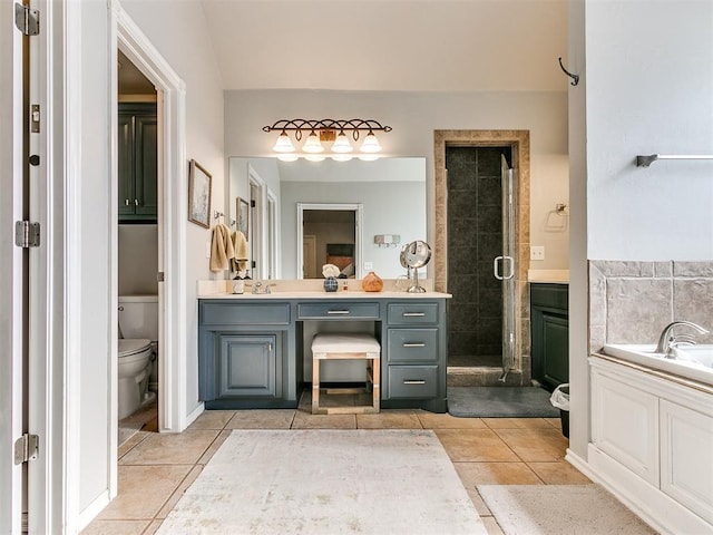 full bathroom featuring tile patterned floors, vanity, independent shower and bath, and toilet