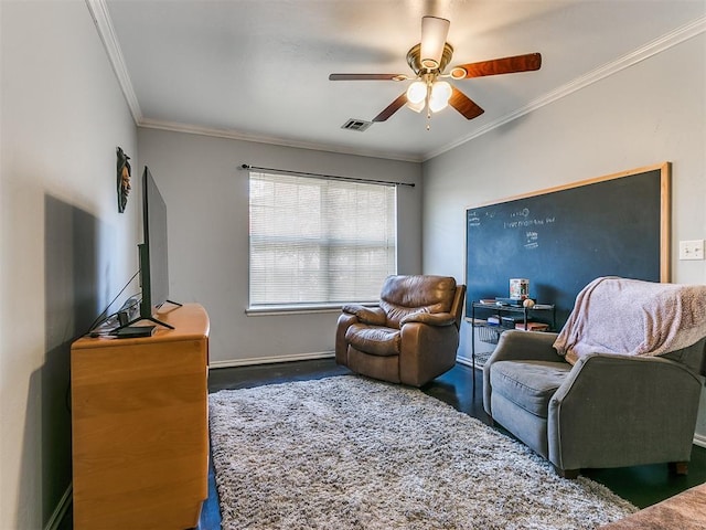 living room with ceiling fan and ornamental molding