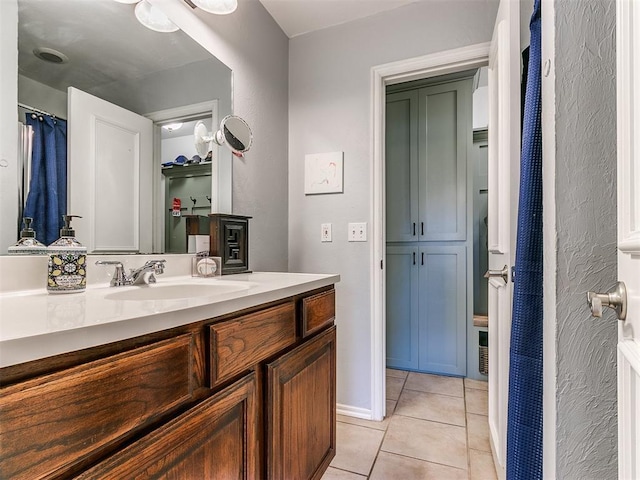 bathroom with tile patterned floors and vanity