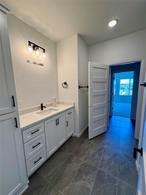 8409 NW 128th St, Oklahoma City, OK 73142 - bathroom with vanity and marble finish flooring