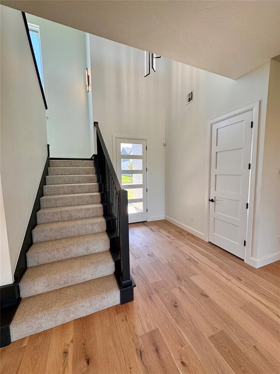 8409 NW 128th St, Oklahoma City, OK 73142 - stairs featuring wood finished floors and baseboards