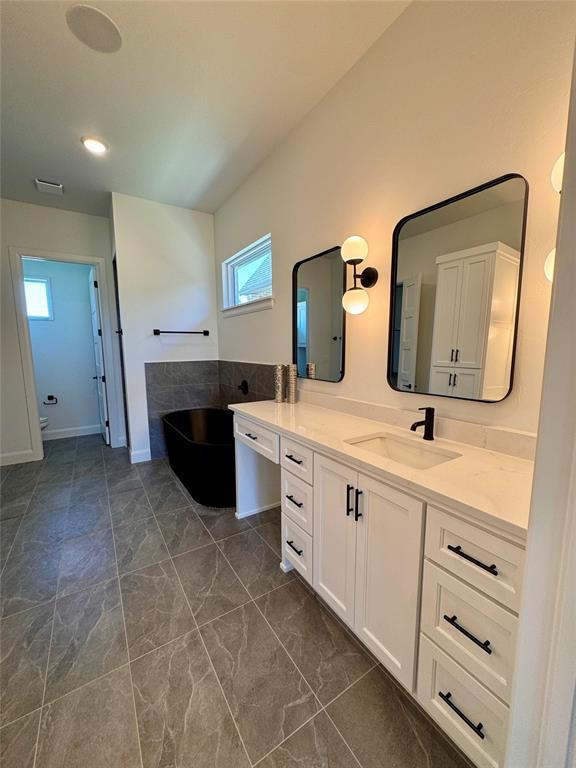 8409 NW 128th St, Oklahoma City, OK 73142 - full bath featuring a bath, healthy amount of natural light, vanity, and marble finish floors