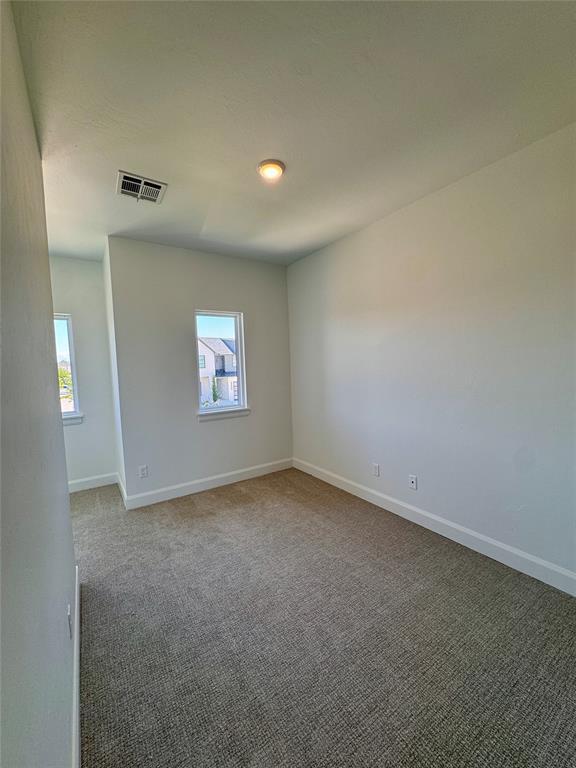 8409 NW 128th St, Oklahoma City, OK 73142 - empty room with plenty of natural light and baseboards