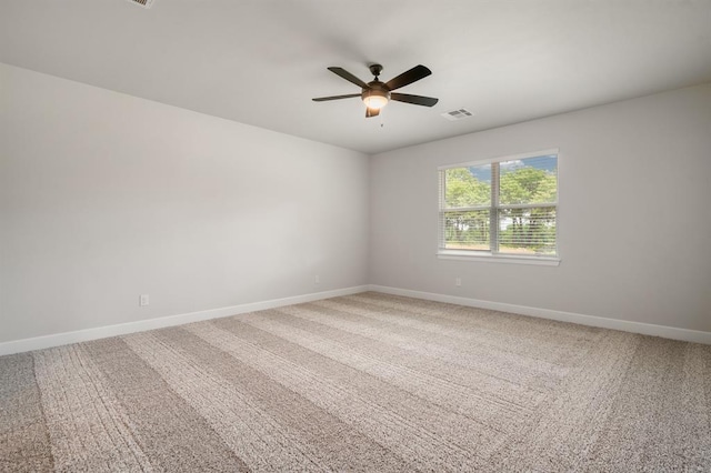 carpeted spare room featuring ceiling fan