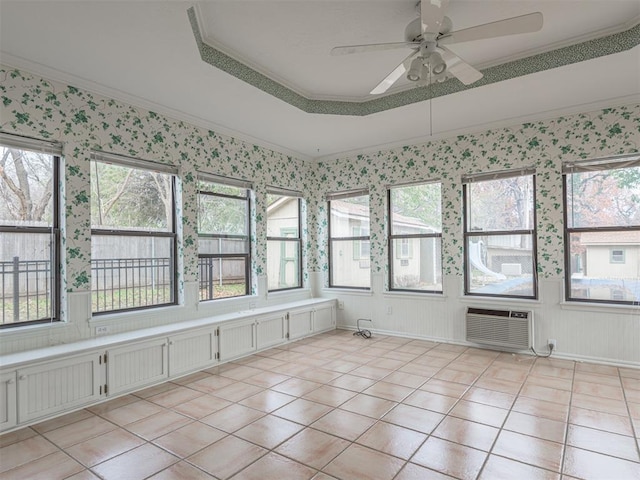 unfurnished sunroom with ceiling fan and plenty of natural light