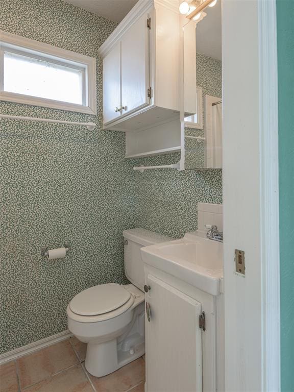 bathroom featuring tile patterned flooring, vanity, and toilet