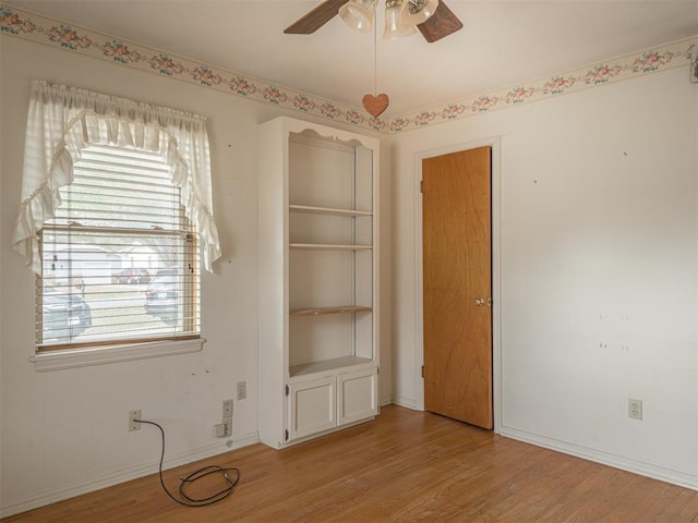 spare room with light wood-type flooring and ceiling fan