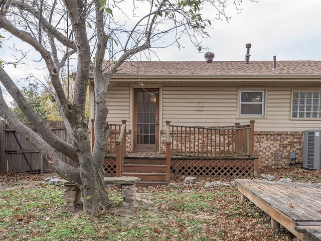 rear view of property featuring cooling unit and a deck