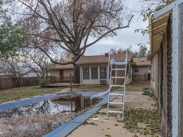 rear view of house featuring a wooden deck