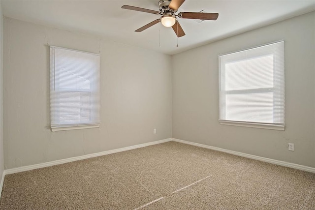 carpeted spare room with ceiling fan