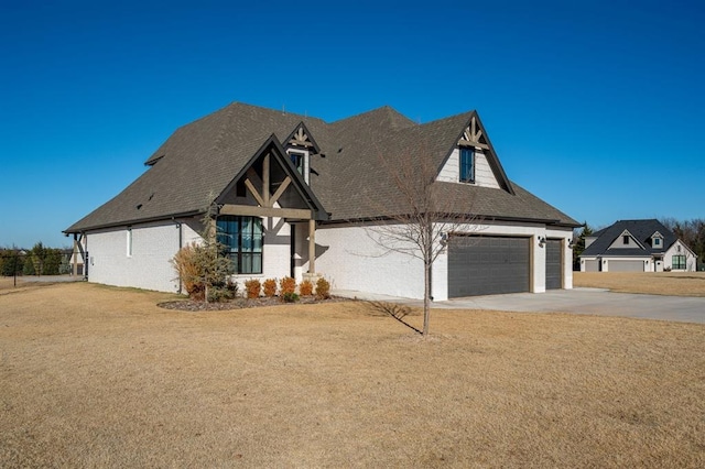 view of front of property with a garage and a front lawn