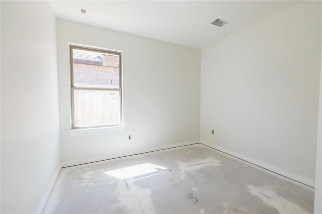 spare room with baseboards