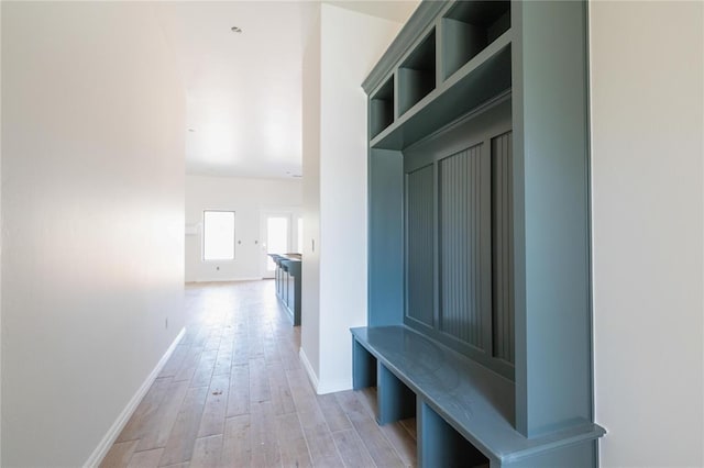 mudroom with light wood-style floors and baseboards