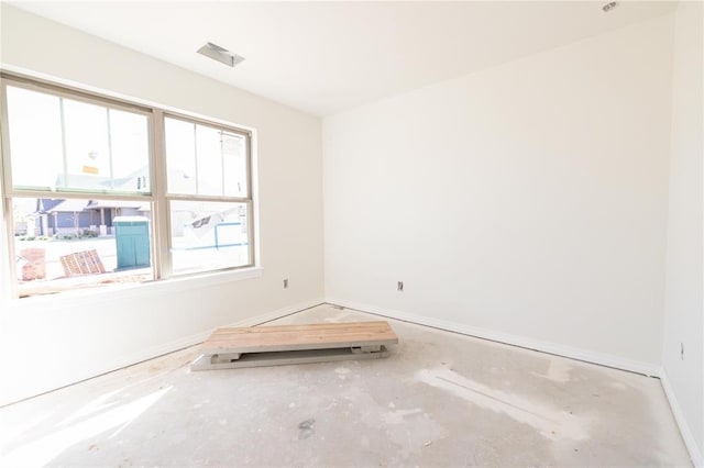spare room with baseboards