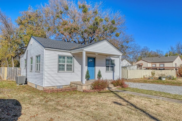 bungalow-style house featuring cooling unit and a front yard