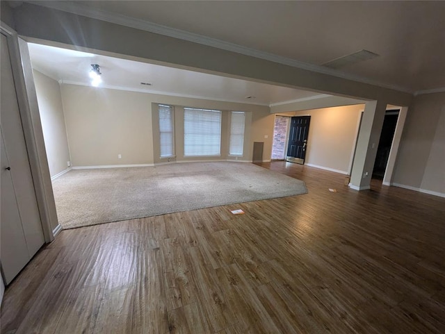 unfurnished living room with wood-type flooring and ornamental molding