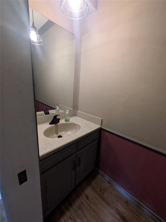 bathroom featuring hardwood / wood-style flooring and vanity