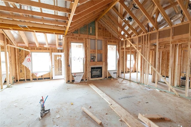 miscellaneous room with a fireplace and lofted ceiling