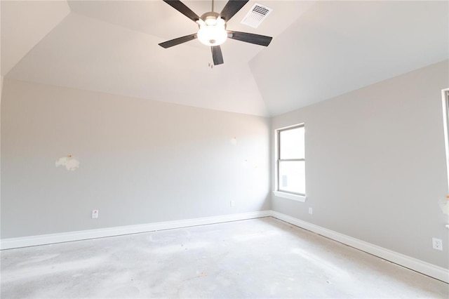 empty room featuring a ceiling fan, visible vents, vaulted ceiling, baseboards, and concrete floors