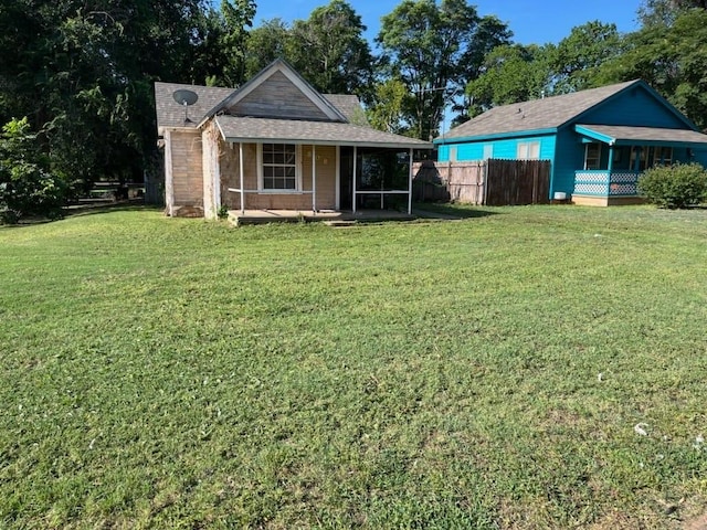 exterior space featuring a sunroom and a yard