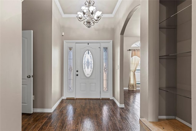 entrance foyer featuring a chandelier, dark hardwood / wood-style floors, and ornamental molding