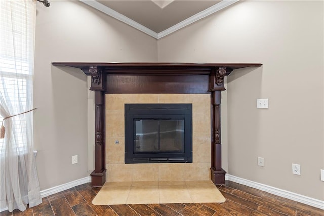 room details featuring hardwood / wood-style floors, ornamental molding, and a tiled fireplace