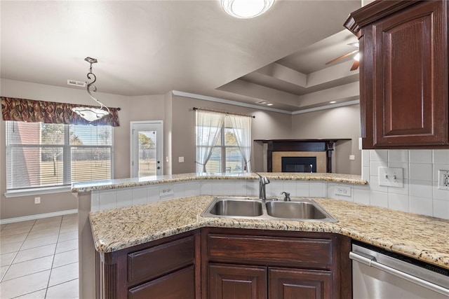 kitchen featuring dishwasher, kitchen peninsula, sink, and tasteful backsplash