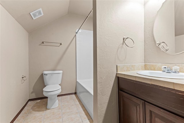 full bathroom with shower / bathing tub combination, vanity, lofted ceiling, tile patterned flooring, and toilet