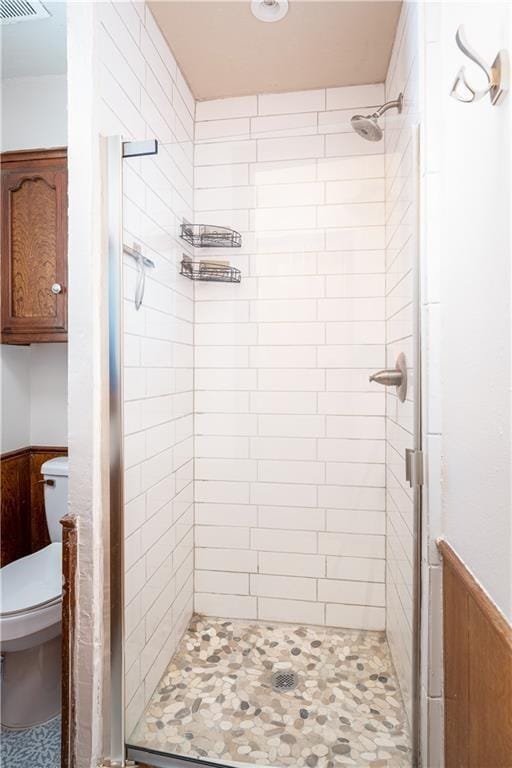 bathroom with toilet and walk in shower