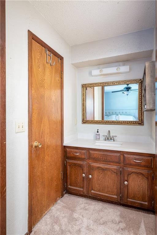 bathroom with a textured ceiling and vanity