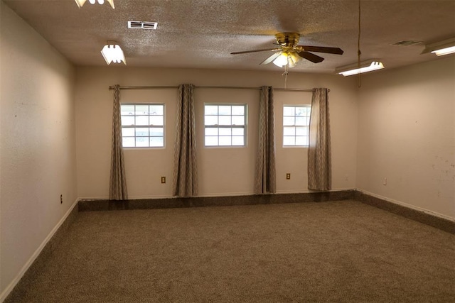 carpeted empty room with a textured ceiling and ceiling fan