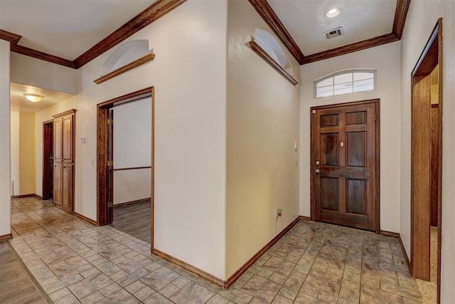 entryway featuring crown molding