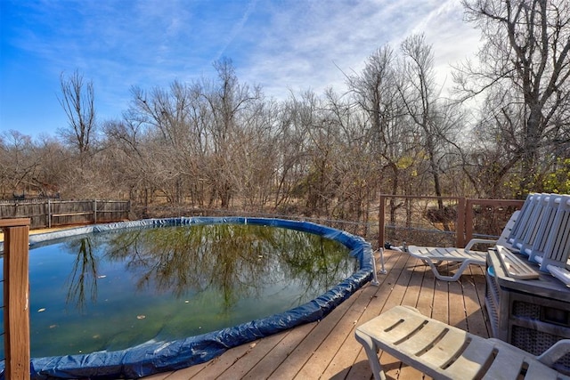 view of swimming pool featuring a wooden deck