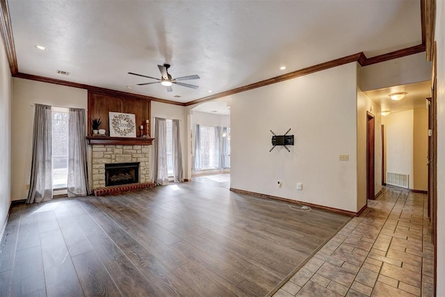 unfurnished living room with ceiling fan, crown molding, a fireplace, and hardwood / wood-style floors