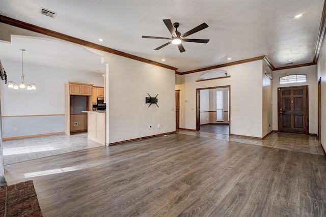 unfurnished living room with ceiling fan with notable chandelier, ornamental molding, and light hardwood / wood-style floors