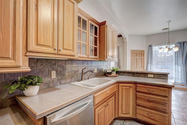 kitchen featuring kitchen peninsula, dishwasher, sink, and a chandelier