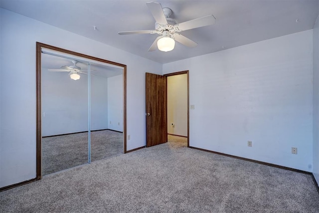 unfurnished bedroom with ceiling fan, a closet, and light carpet