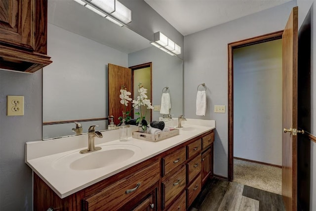 bathroom with hardwood / wood-style floors and vanity