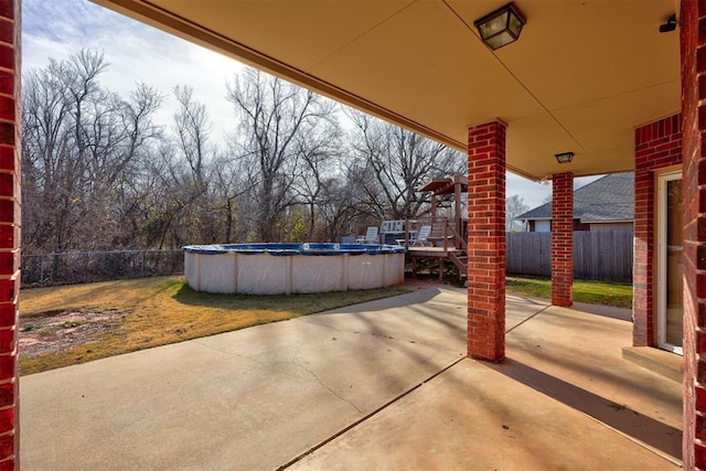 view of patio with a fenced in pool