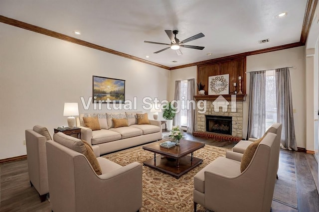 living room with ceiling fan, hardwood / wood-style floors, ornamental molding, and a fireplace