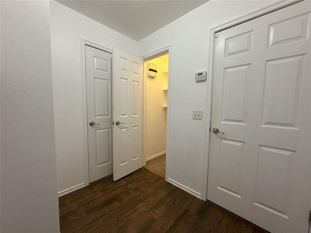 corridor with dark hardwood / wood-style floors