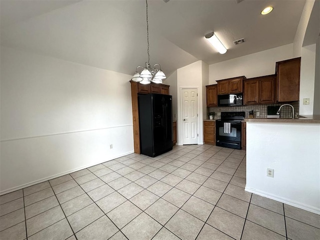 kitchen with lofted ceiling, backsplash, black appliances, light tile patterned floors, and a notable chandelier