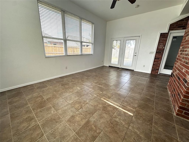 unfurnished room with a wealth of natural light and ceiling fan