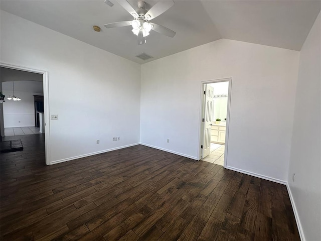 spare room with ceiling fan, dark wood-type flooring, and lofted ceiling