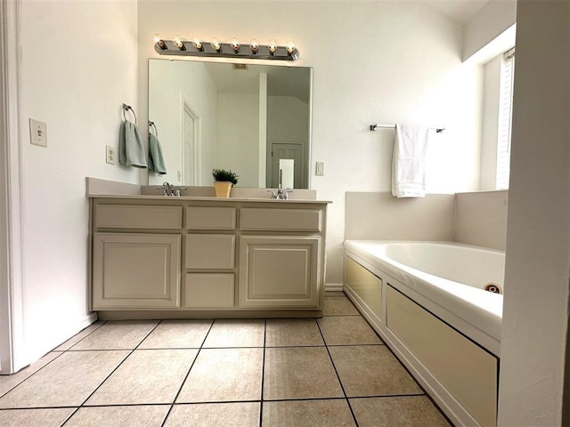 bathroom featuring tile patterned floors, vanity, and a bathtub